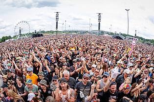 Daniel Karmann/dpa | Vorne Musik, hinten Riesenrad: Bei Festivals erwarten die Fans mittlerweile mehr als Band-Auftritte. (Archivbild)